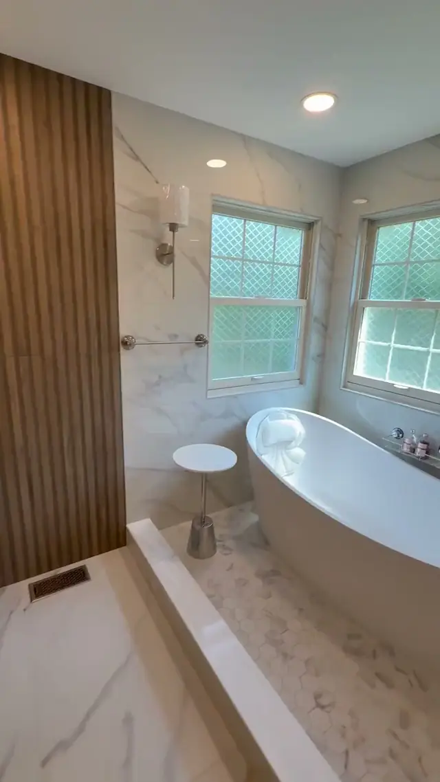 Walkthrough of a finished primary bathroom in Burlington Township, NJ, starting at a freestanding tub under two windows
